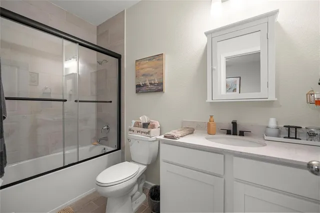 a bathroom with a toilet sink and shower
