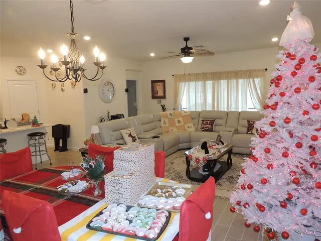 a living room with furniture and a chandelier