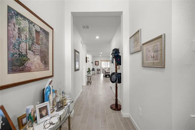 a view of a living room with furniture and wooden floor