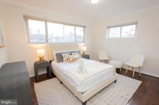 a bedroom with a bed and a large window