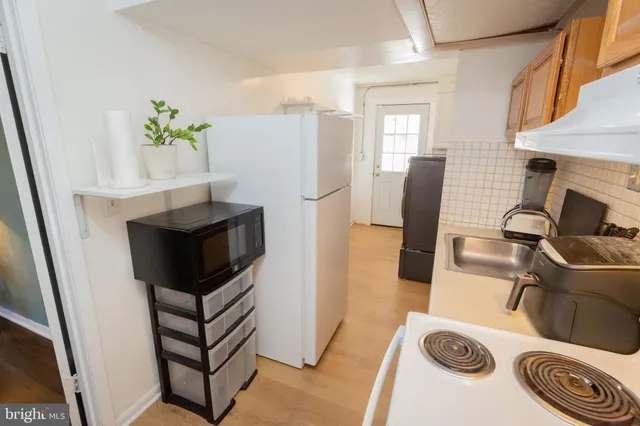 a white refrigerator freezer sitting inside of a kitchen