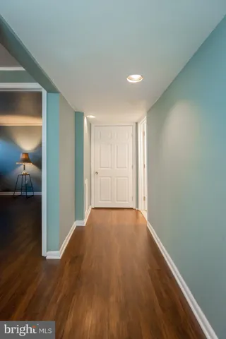 a view of hallway with wooden floor
