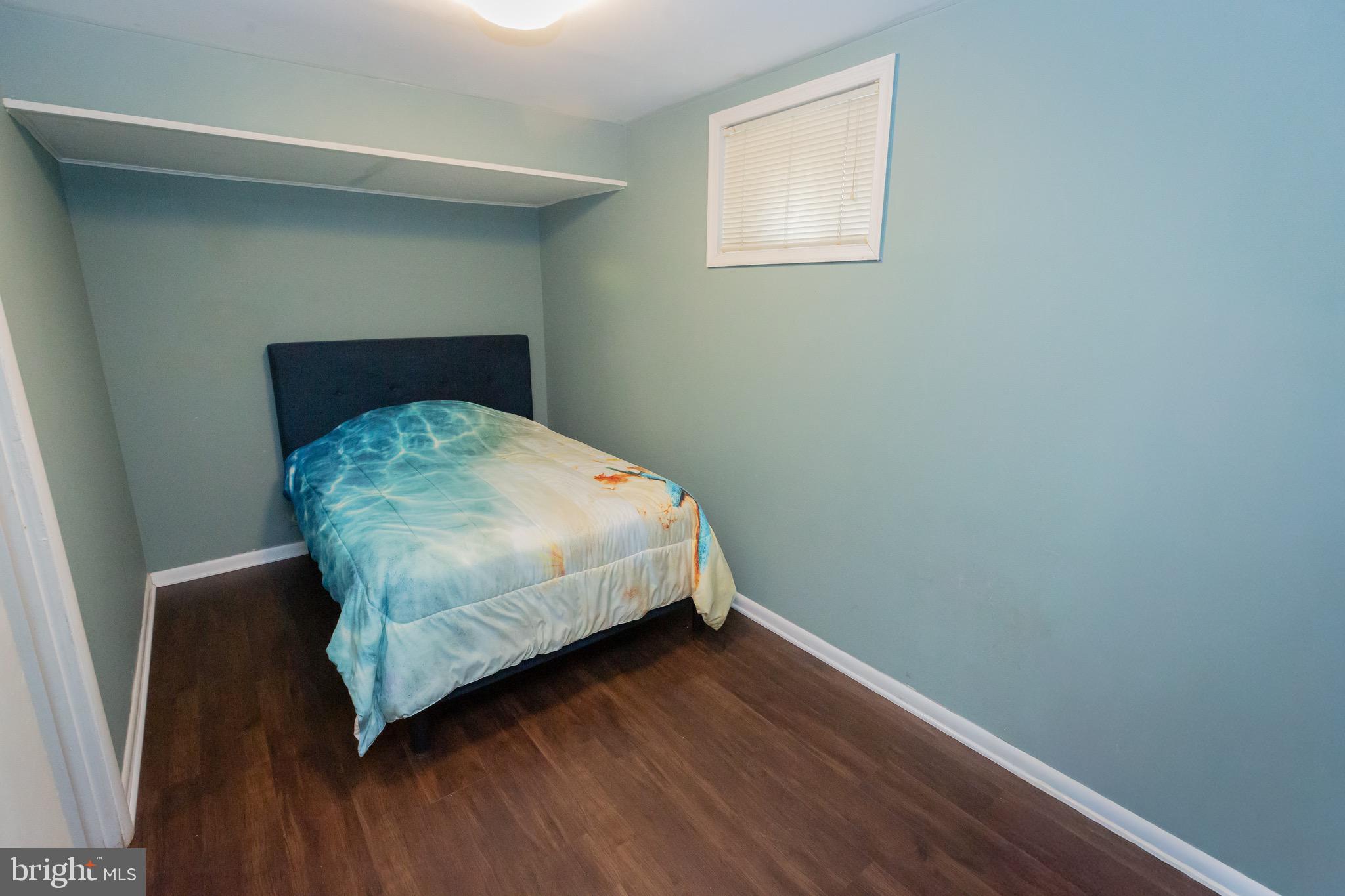 3945 Wendy Lane Silver Spring, MD 20906 - Photo 36 of 45 a bedroom with a bed and wooden floor