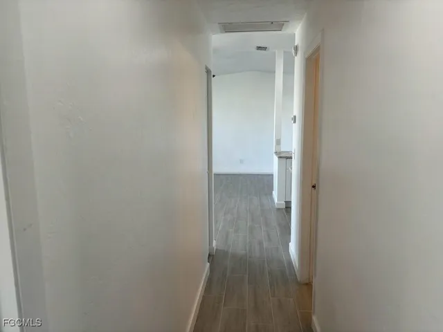 a view of a hallway with wooden floor