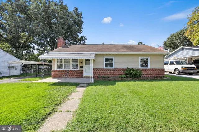 a front view of a house with a yard table and chairs