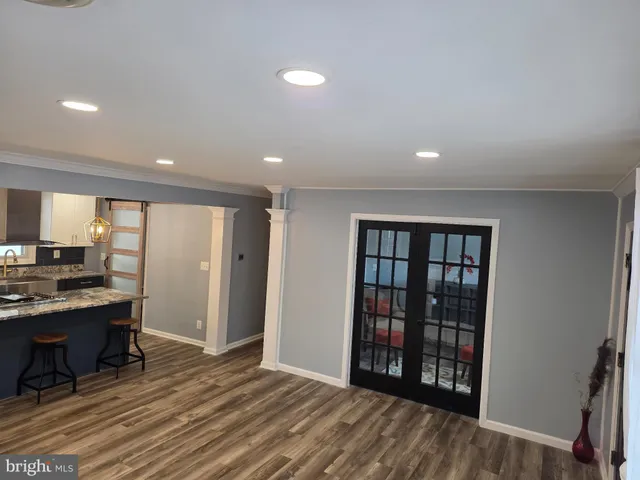a view of a kitchen with furniture and wooden floor