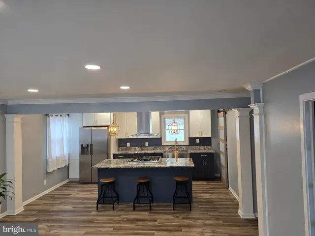 a kitchen with stainless steel appliances a refrigerator and a stove top oven