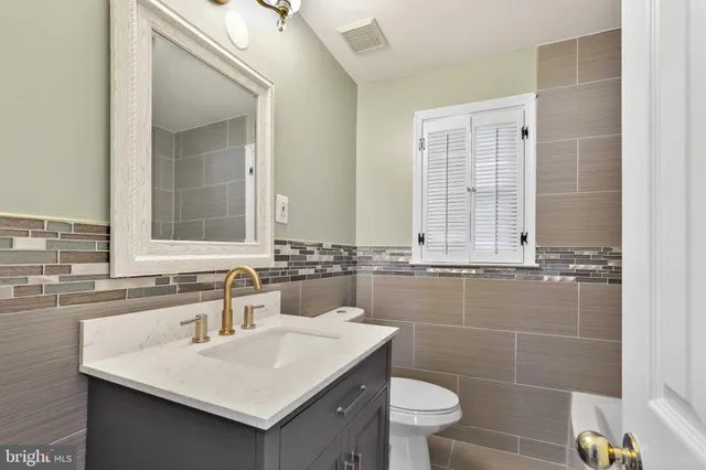 a bathroom with a sink toilet and mirror