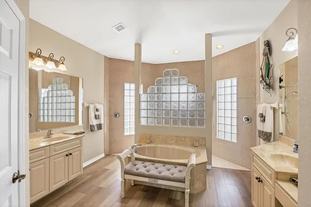 a spacious bathroom with a sink a mirror and a shower