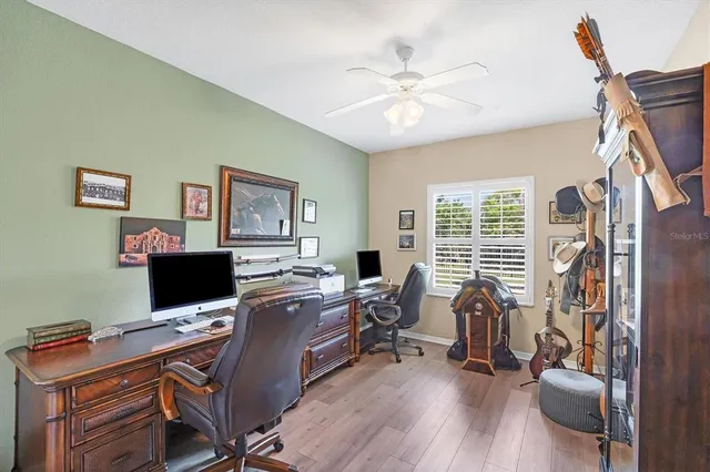 a view of a workspace with furniture and wooden floor