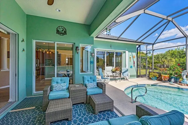 a swimming pool with patio outdoor seating and yard