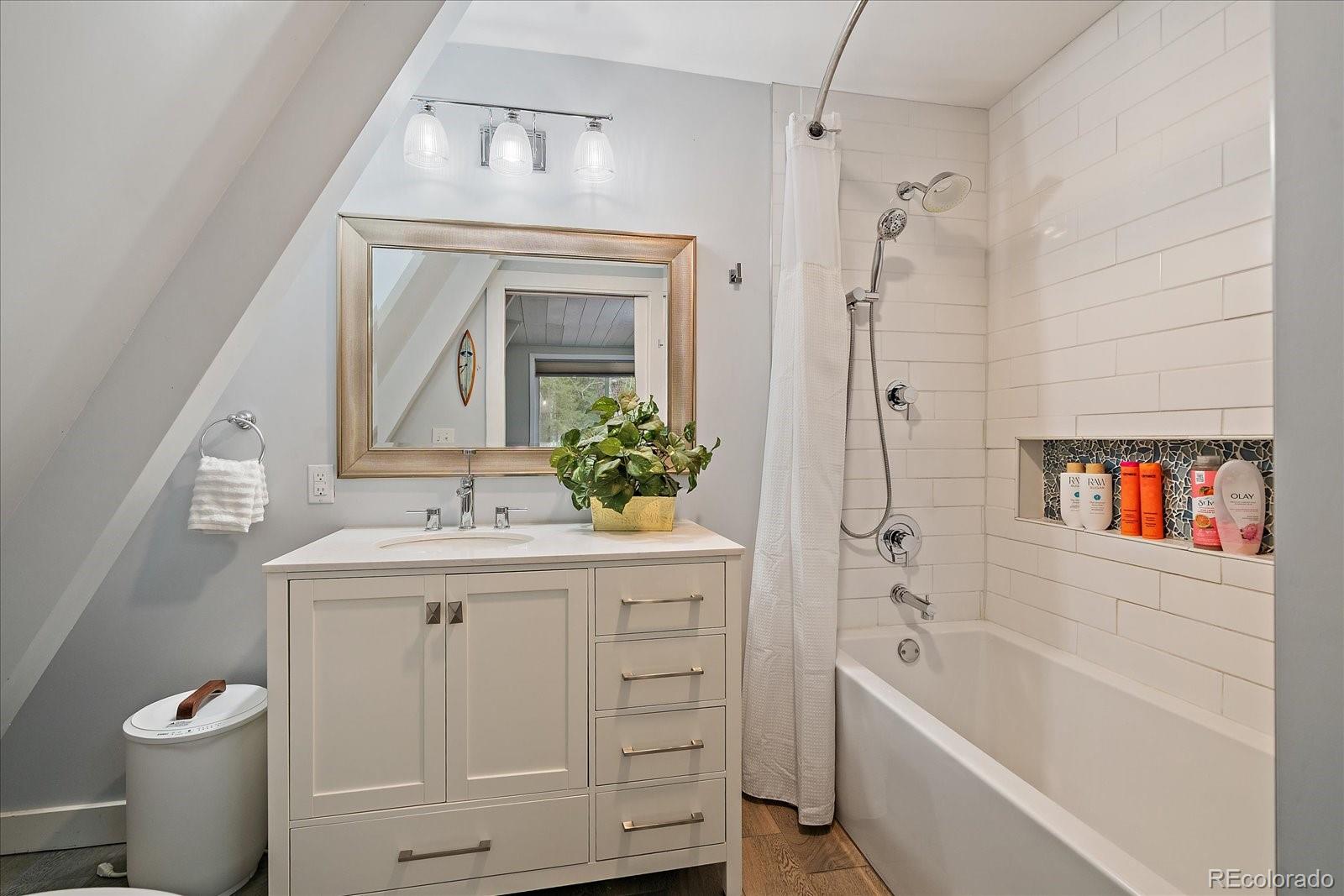 307 Snyder Mountain Road Evergreen, CO 80439 - Photo 20 of 41 a bathroom with a sink a toilet and a bathtub