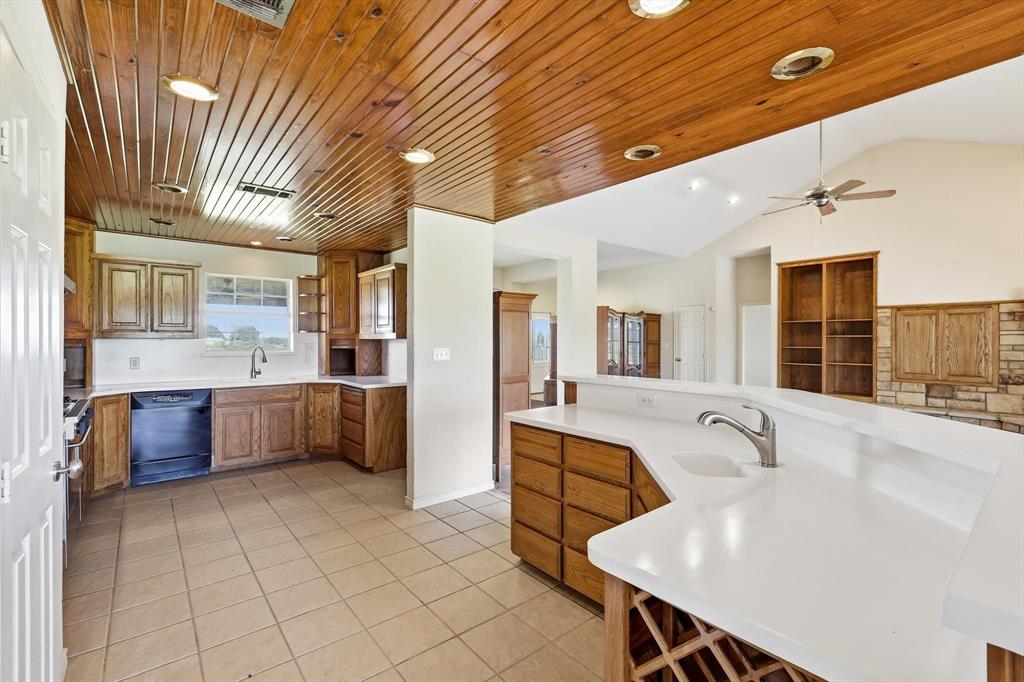 12190 Bell Road Pilot Point, TX 76258 - Photo 15 of 39 Kitchen featuring a wood plank ceiling with recessed lighting, integrated dishwasher, white countertops, and a built-in wine rack