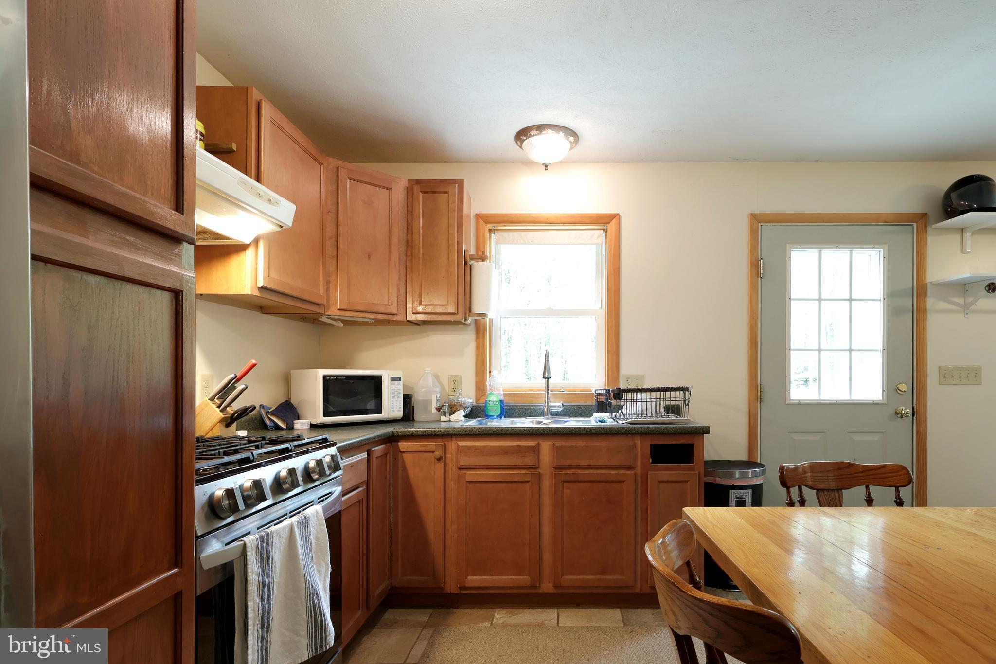 358 Buckridge Road Howard, PA 16841 - Photo 13 of 40 a kitchen with a sink stove and microwave