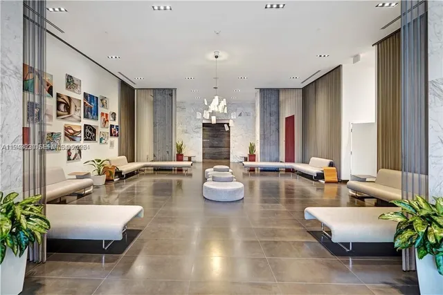 a living room with fireplace furniture and a potted plant