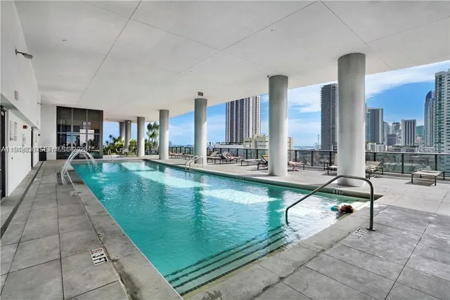 a swimming pool with outdoor seating