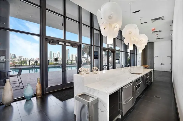 a large white kitchen with a large window