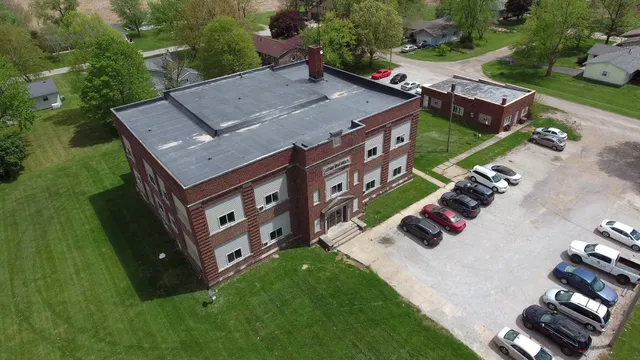 an aerial view of a house with garden space and street view