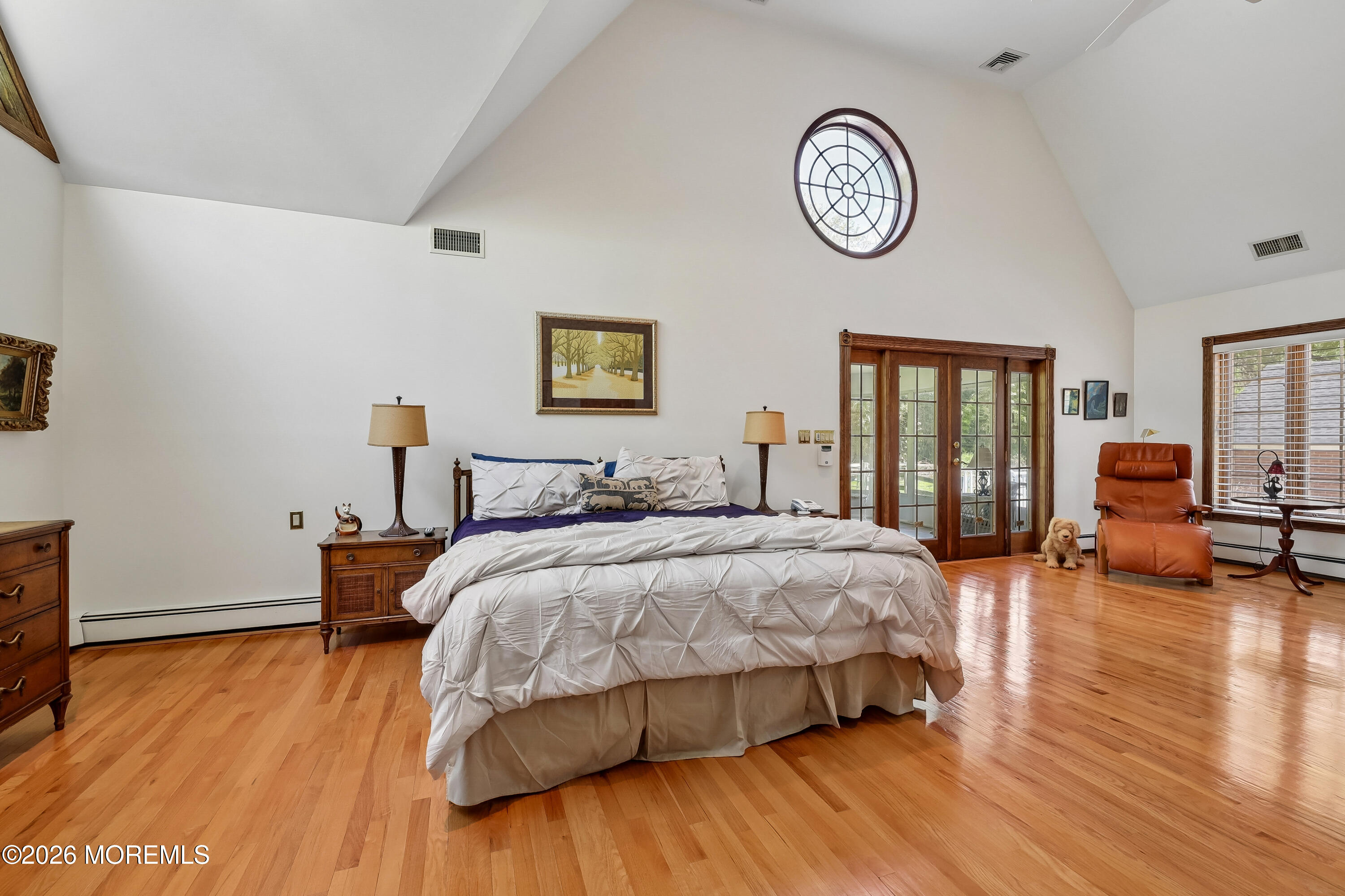 187 Hockhockson Road Colts Neck, NJ 07722 - Photo 30 of 55 a spacious bedroom with a bed and a table in it
