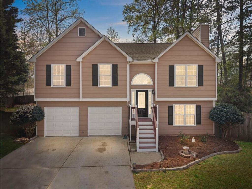 2993 Everglades Court Acworth, GA 30101 - Photo 1 of 1 a view of a yard in front of a house with large windows