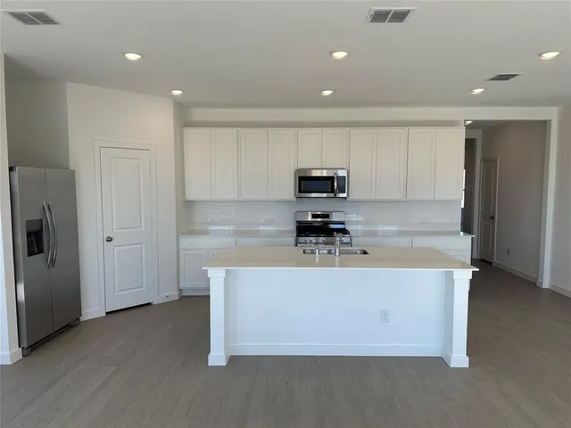a kitchen with a sink and a bathtub