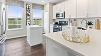 1075 Atterberg Road, Unit 4105 South Elgin, IL 60177 - Photo 5 of 18 a kitchen with stainless steel appliances granite countertop a sink a stove and a refrigerator