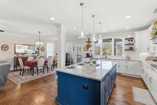 a living room with furniture wooden floor and window