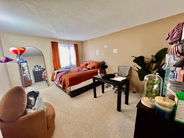 a bedroom with furniture and a potted plant