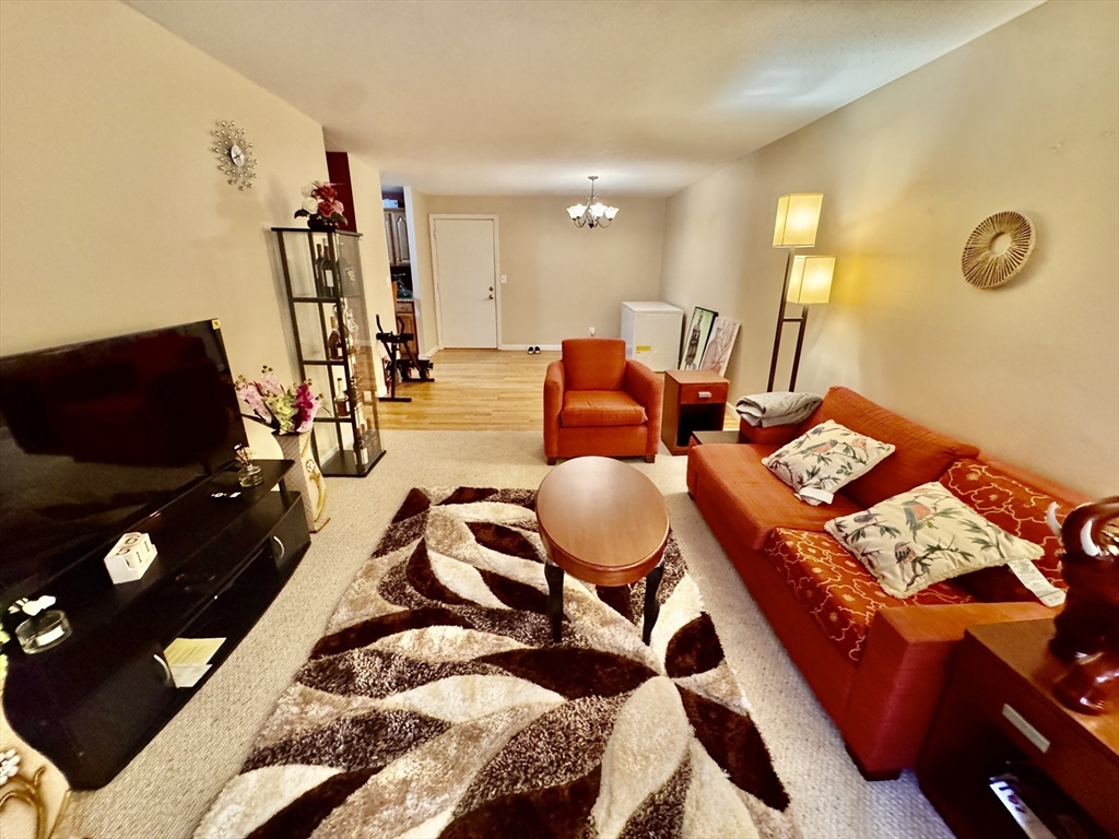 3 Greenbriar Drive, Unit 303 North Reading, MA 01864 - Photo 13 of 16 a living room with furniture and flat screen tv