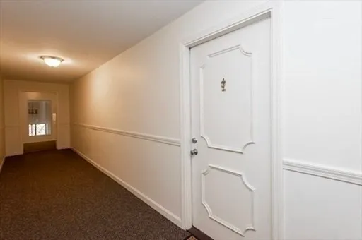a view of a hallway with an entryway