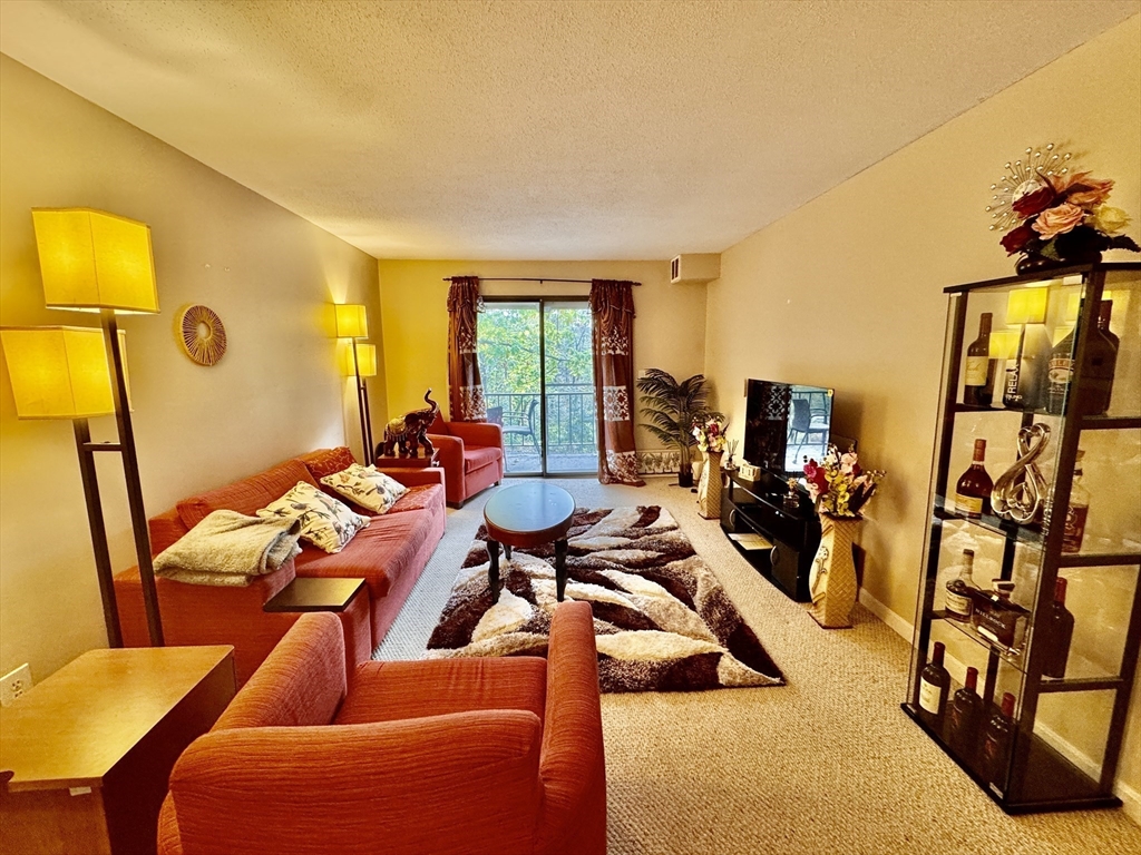 3 Greenbriar Drive, Unit 303 North Reading, MA 01864 - Photo 2 of 16 a view of a livingroom with furniture and lounge chair