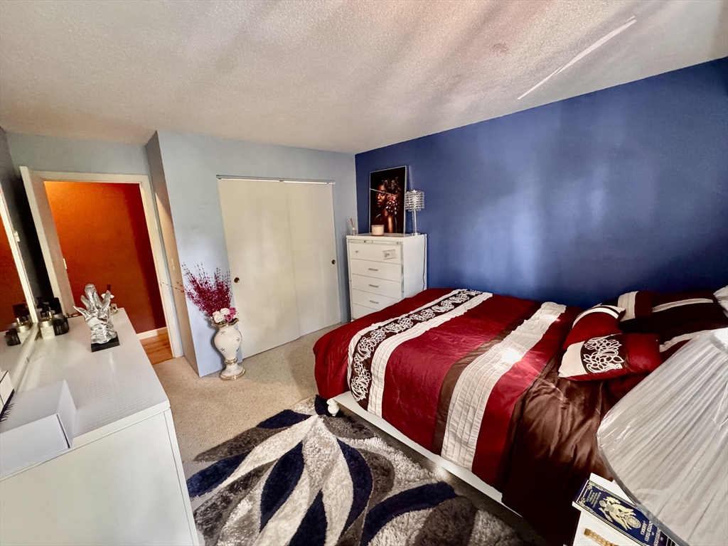3 Greenbriar Drive, Unit 303 North Reading, MA 01864 - Photo 8 of 16 a bedroom with a bed and a couch