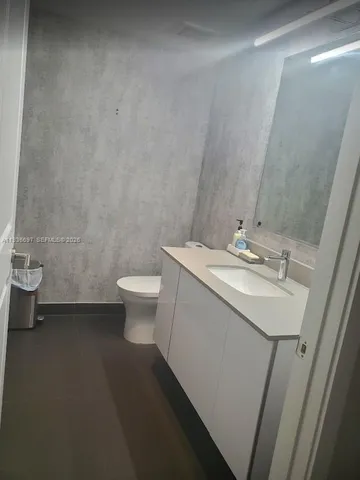 a kitchen with granite countertop white cabinets and stainless steel appliances