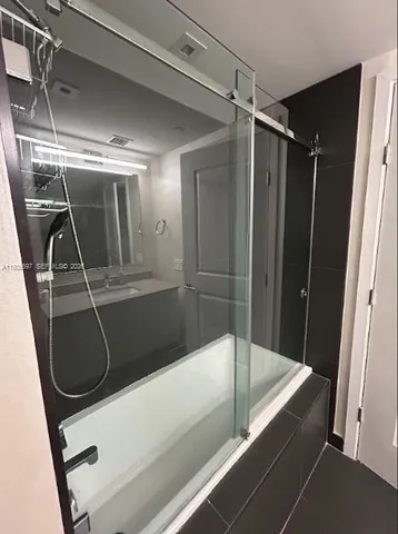 a spacious bedroom with a large bed and a large window