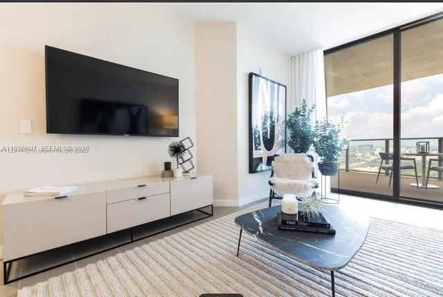 a view of a balcony dining area with furniture and wooden floor