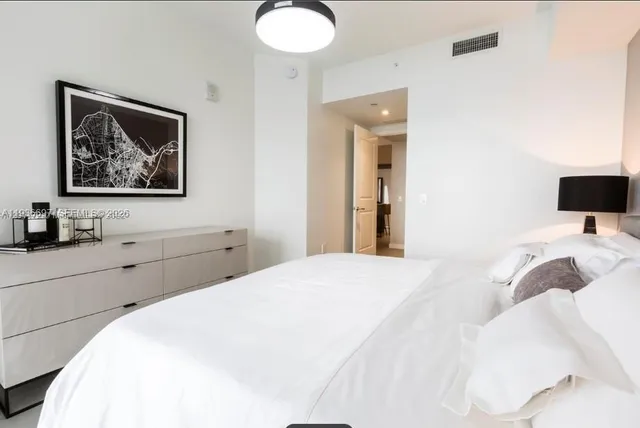 a living room with lots of furniture and gym equipment