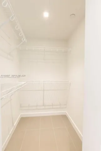 an open kitchen with wooden floor and large windows