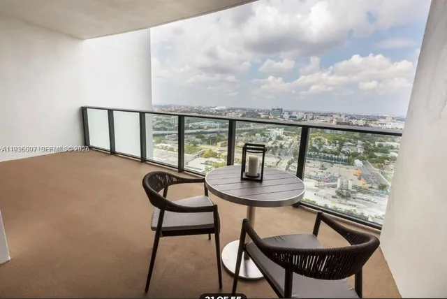 a view of a town with swimming pool and mountains in the background