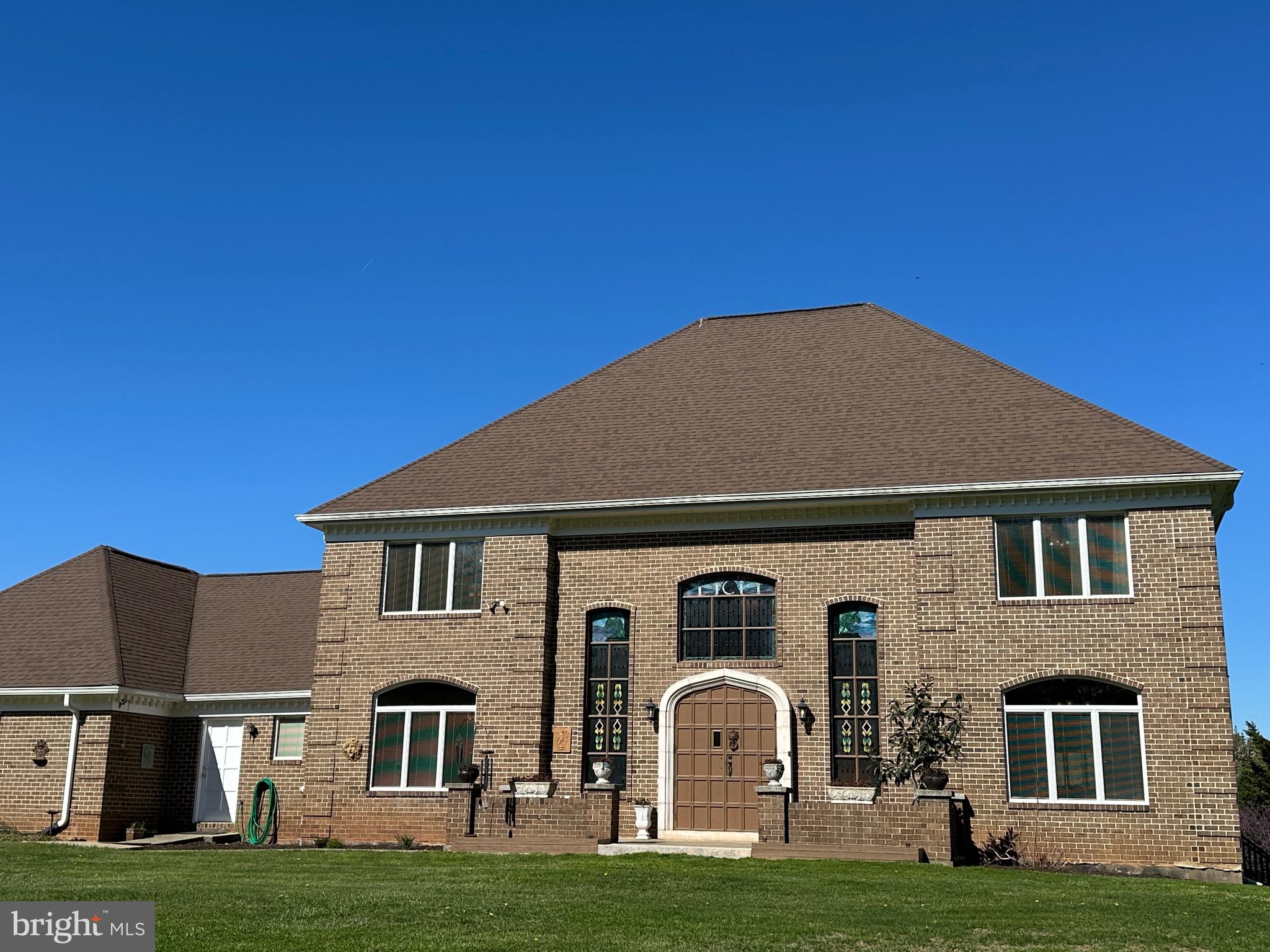 a front view of a house with a garden