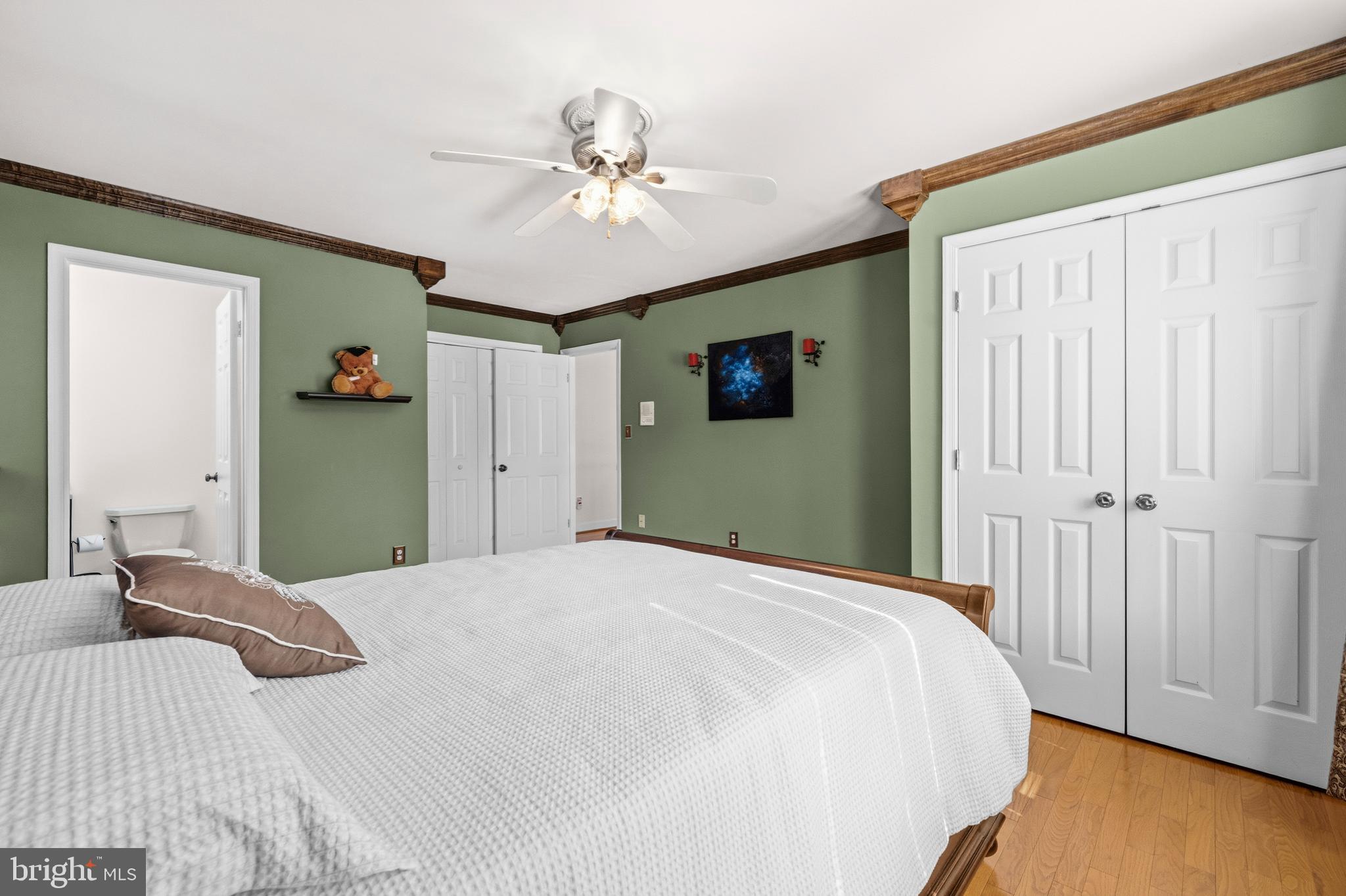 16170 Ed Warfield Road Woodbine, MD 21797 - Photo 39 of 80 a bedroom with a bed and a chandelier