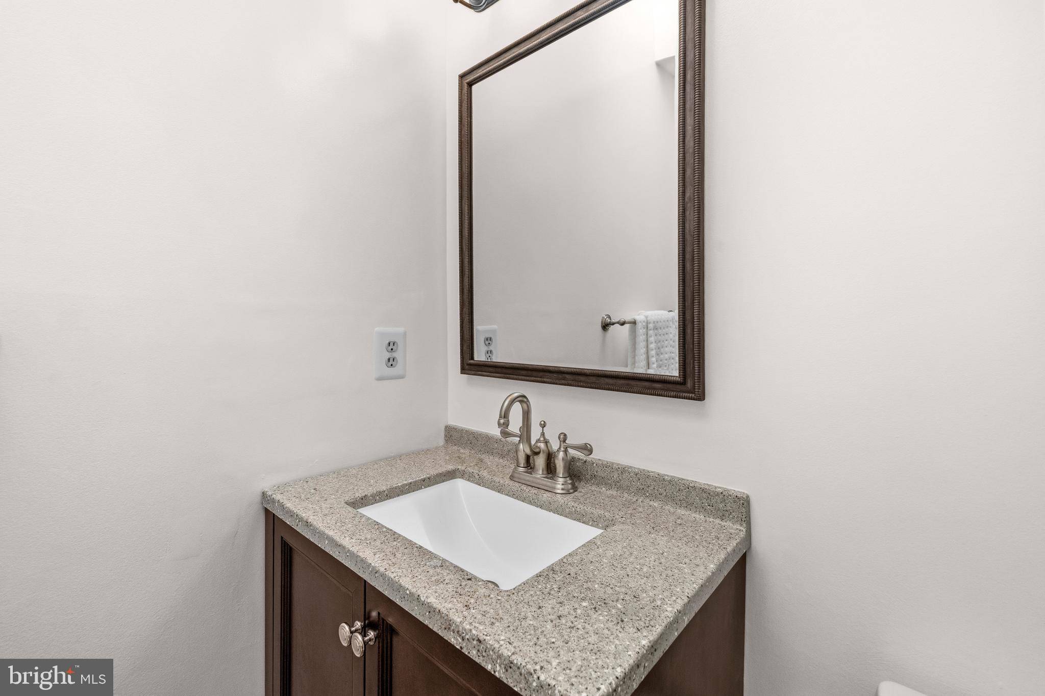 16170 Ed Warfield Road Woodbine, MD 21797 - Photo 40 of 80 a bathroom with a granite countertop sink and a mirror