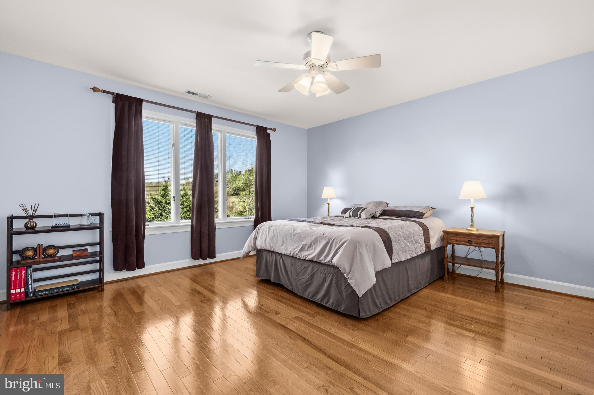 16170 Ed Warfield Road Woodbine, MD 21797 - Photo 50 of 80 a spacious bedroom with a bed and a chandelier