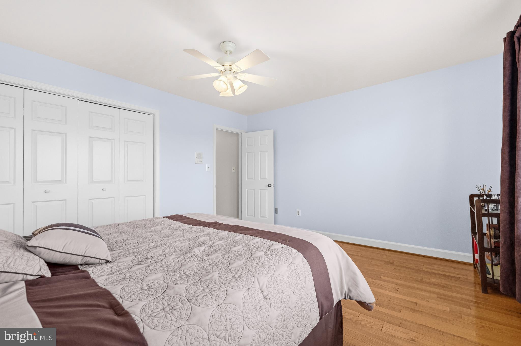 16170 Ed Warfield Road Woodbine, MD 21797 - Photo 51 of 80 a bedroom with a bed and wooden floor