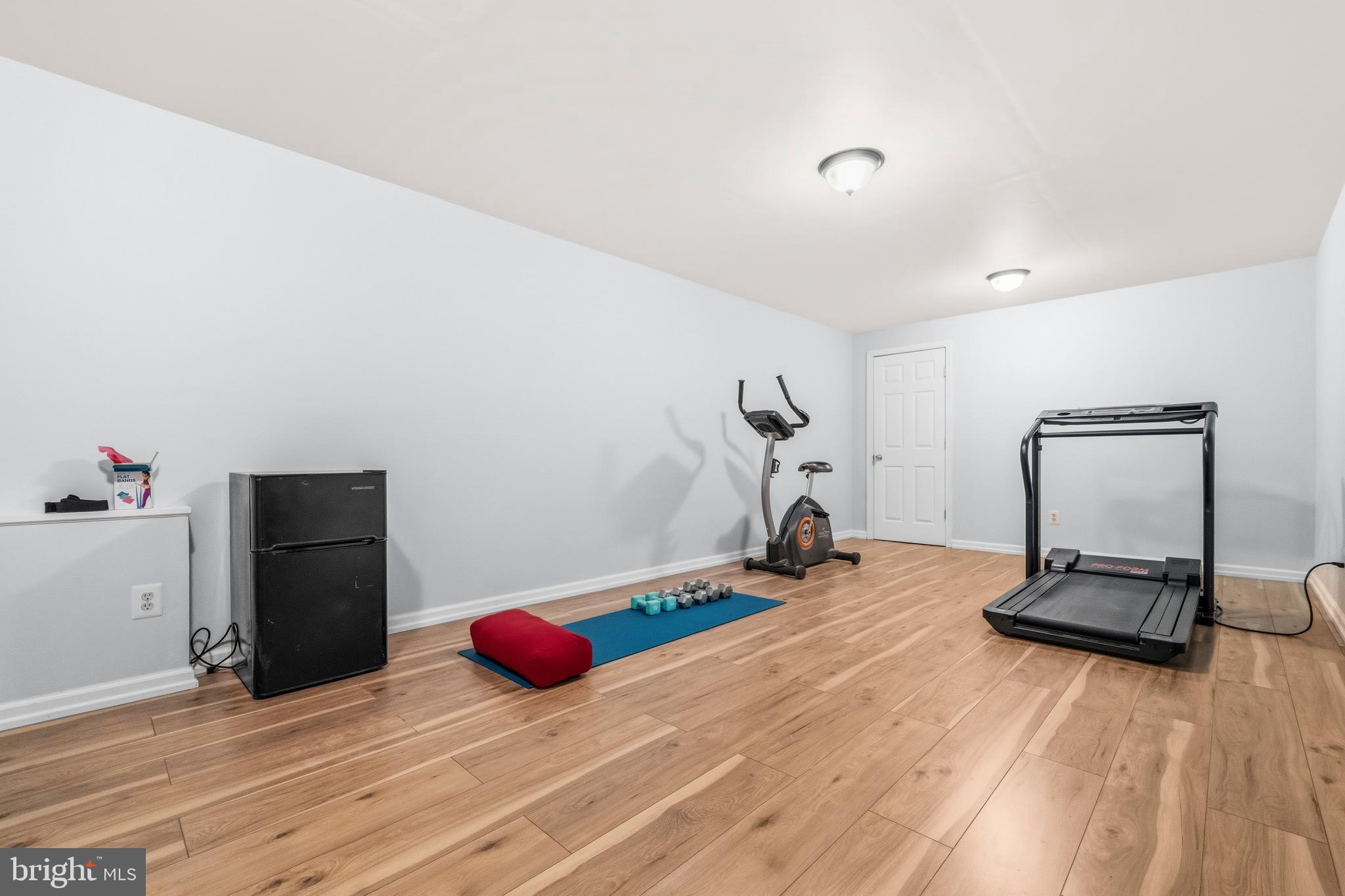 16170 Ed Warfield Road Woodbine, MD 21797 - Photo 61 of 80 a room with gym equipment and wooden floor