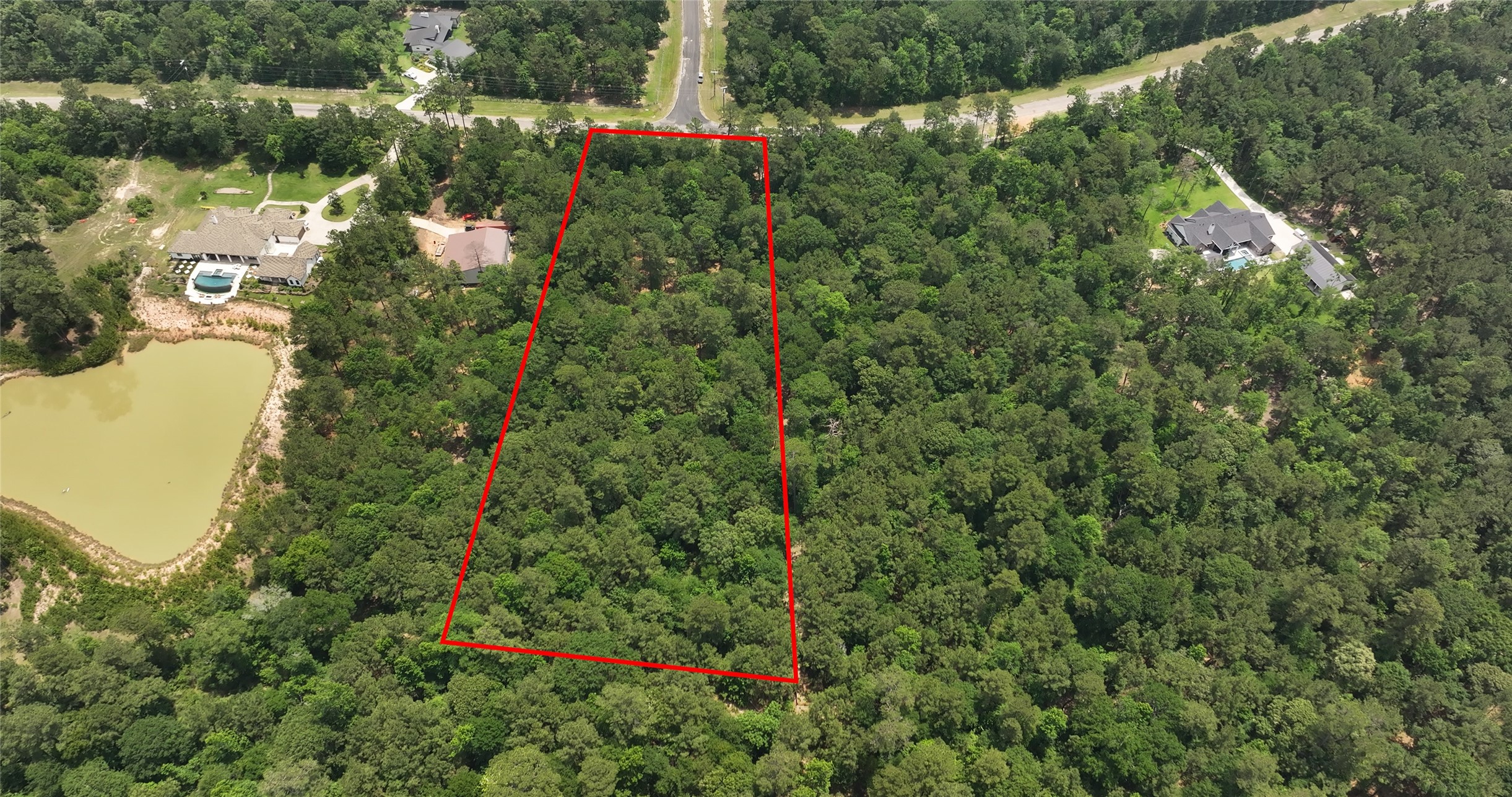 167 B Winchester Road Huntsville, TX 77340 - Photo 4 of 25 an aerial view of a house with a yard and lake view