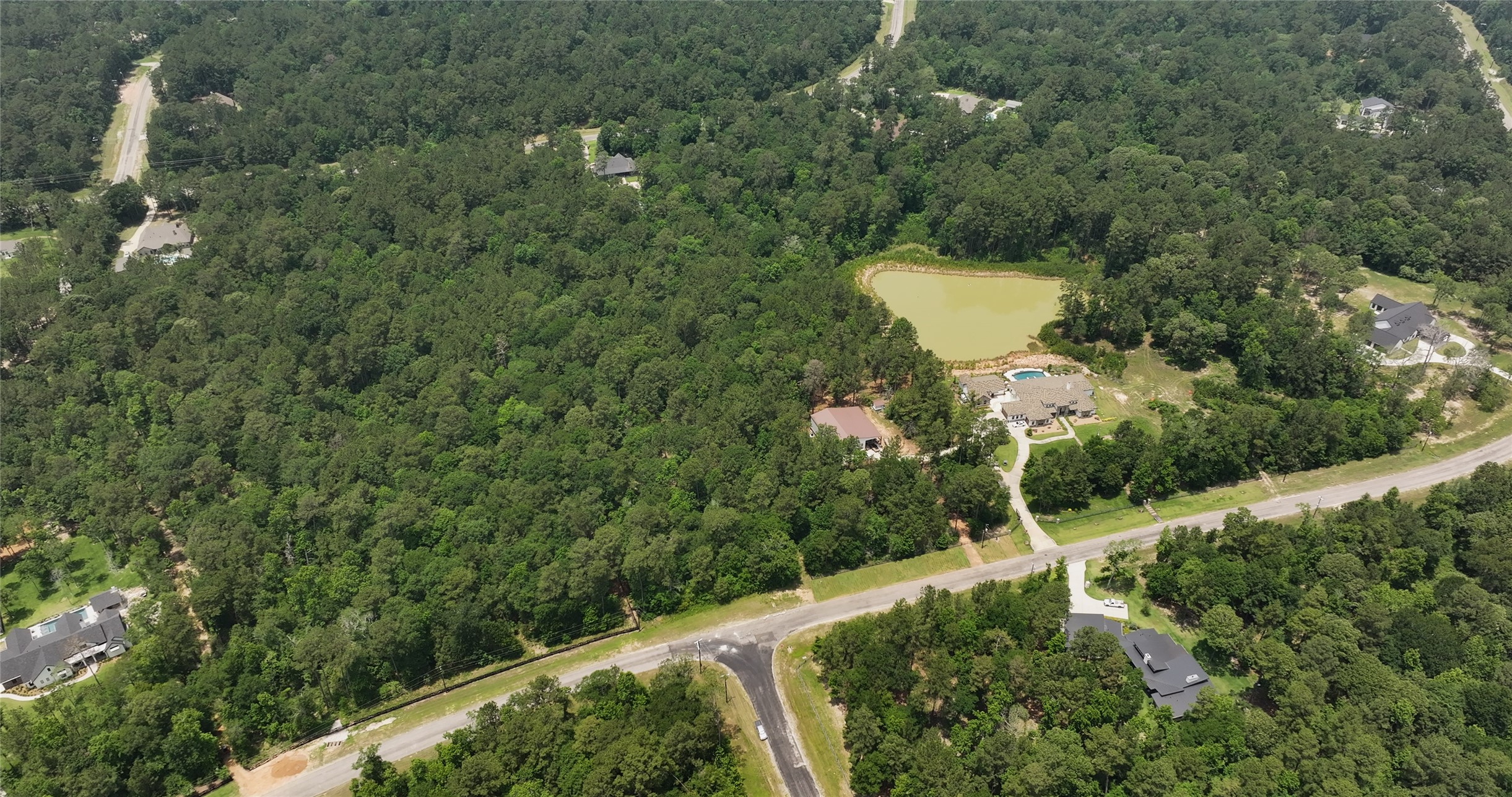 167 B Winchester Road Huntsville, TX 77340 - Photo 7 of 25 an aerial view of a house with a yard and outdoor seating