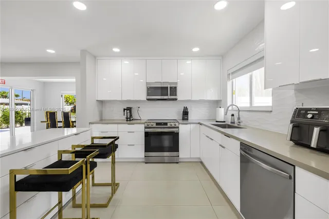 a kitchen with a stove a sink and a refrigerator