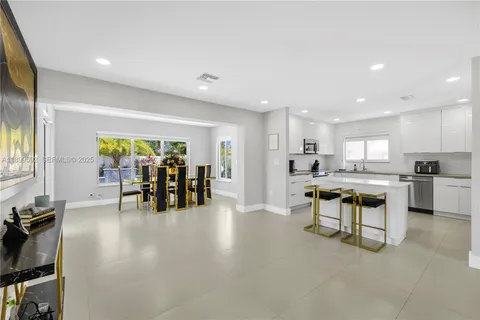 a view of a kitchen with dining table and chairs