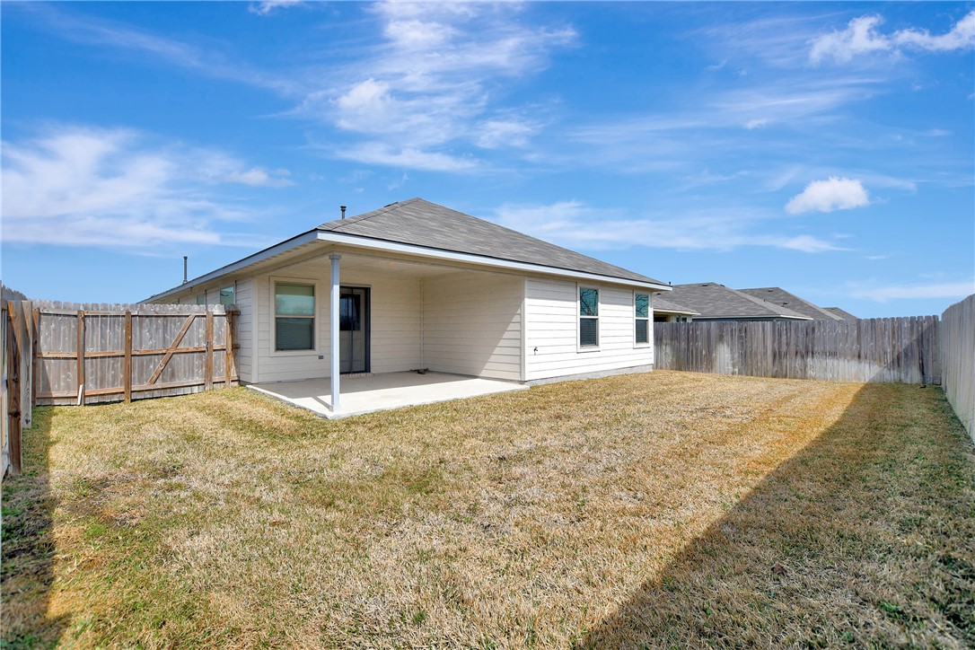 909 Davy Street Brenham, TX 77833 - Photo 28 of 35 Back of property featuring a patio area and a fenced backyard