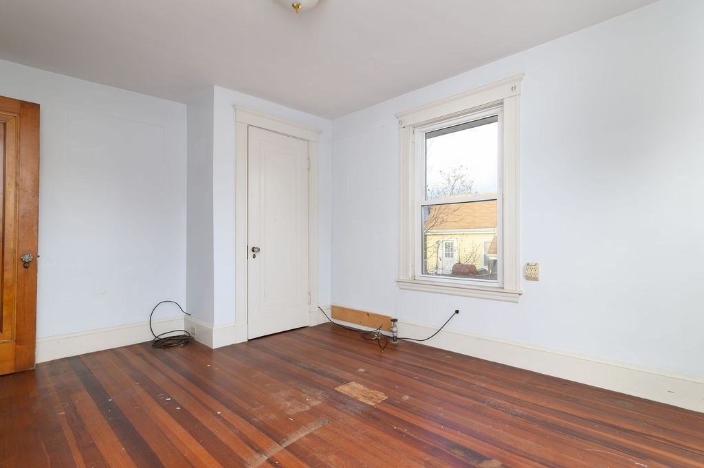 56 Putnam Street Weymouth, MA 02189 - Photo 16 of 39 an empty room with wooden floor and windows